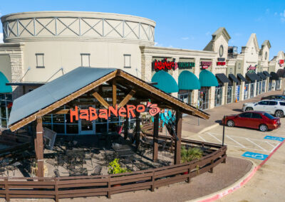 The front patio of Habanero's Fresh Mex Cantina and the storefronts for a variety of thriving businesses in the Park Glen Summit shopping center in Fort Worth TX