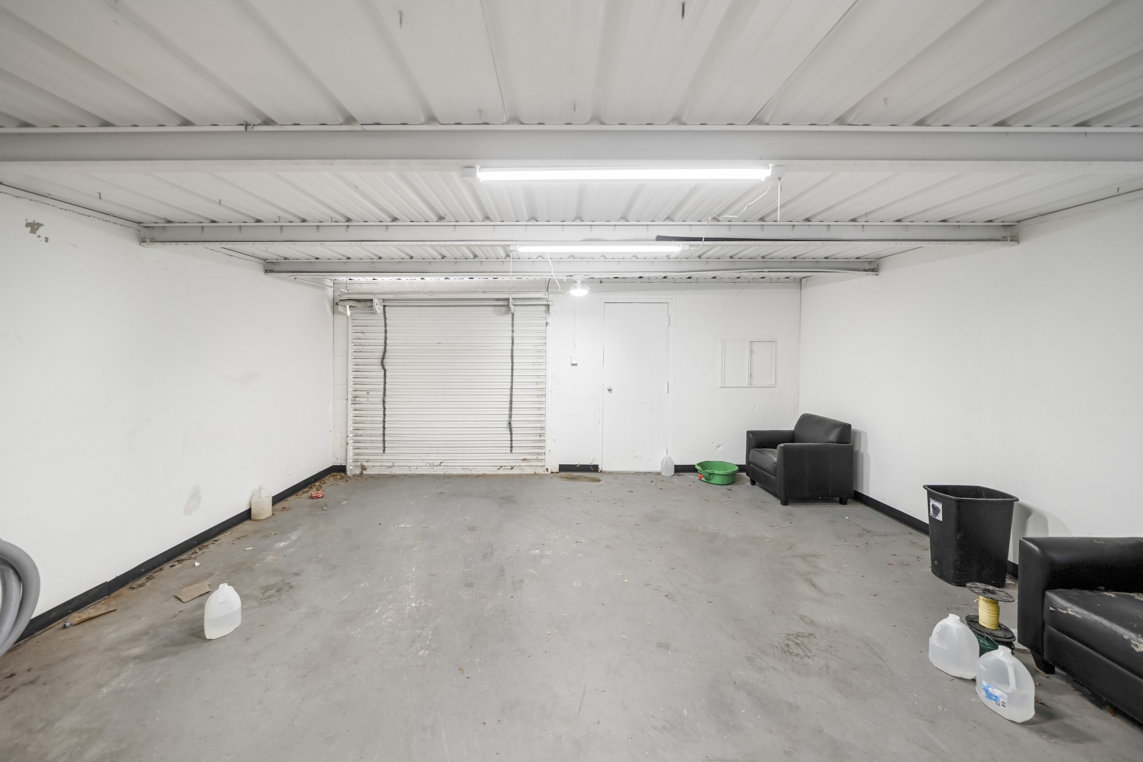 interior of the Flex suite 1004, with bay door, available for lease at the Santa Fe Shopping Center in Weatherford TX