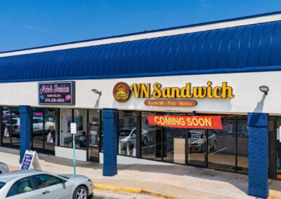 Storefronts for a hair salon and VN Sandwich Vietnamese restaurant at the Concord Corners shopping center in Smyrna GA