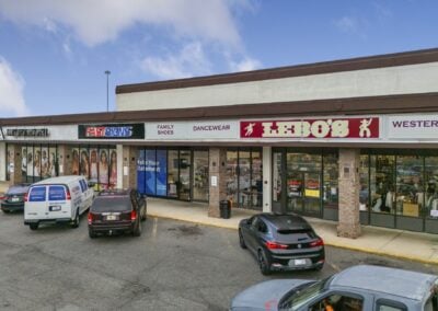 A row of bustling tenants, including Lebo's and FastSigns, with multiple cars out front at the Akers Center in Gastonia NC