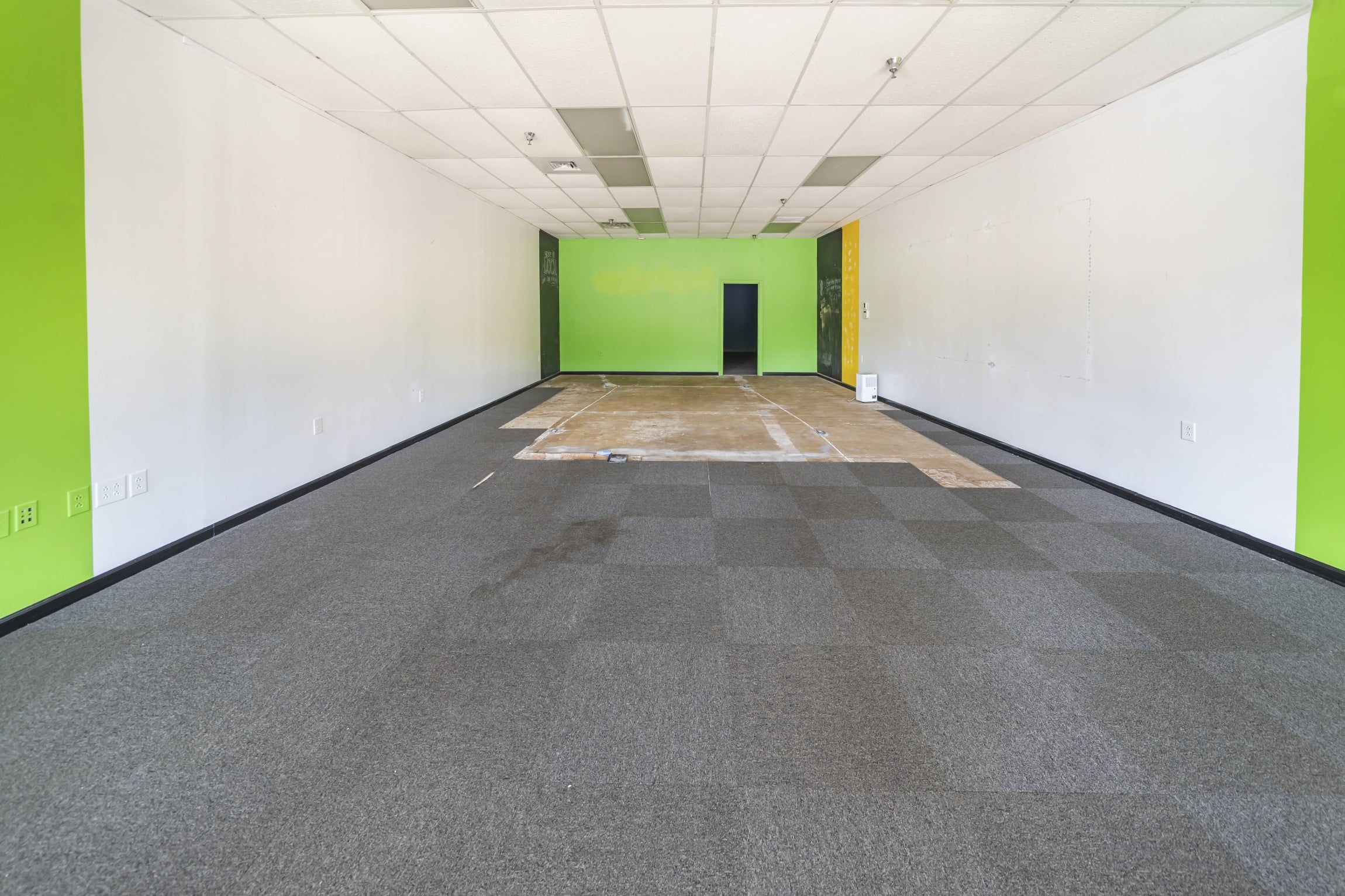 main retail floor for suite 10 at Marion City Square, with grey carpet in the front and bare concrete near the back wall
