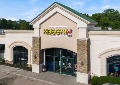 The entrance to We Rock The Spectrum Kid's Gym in Cordova TN, with modern stone pillars on either side of the doors