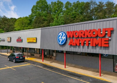 A row of popular businesses, including a Workout Anytime gym, Taste of China, and Papa Johns pizza, in the Centerview Plaza shopping center in China Grove NC