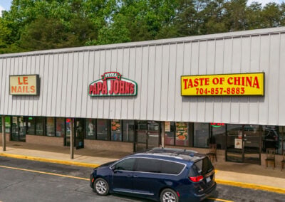 A row of popular businesses, including Taste of China, a nail salon, and Papa Johns pizza, in the Centerview Plaza shopping center in China Grove NC