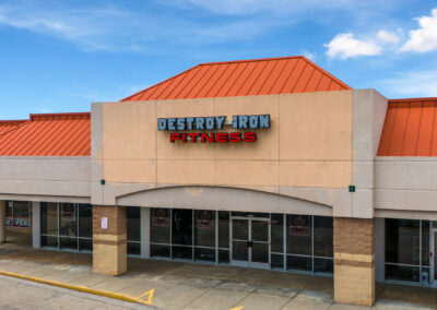 The storefront of Destroy Iron Fitness, a popular gym in the High Ridge Center shopping center in Racine WI, where additional Retail and Restaurant suites are available.