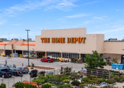 The Home Depot shadow-anchoring High Ridge Center in Racine WI, with an outdoor garden center and cars in the parking lot